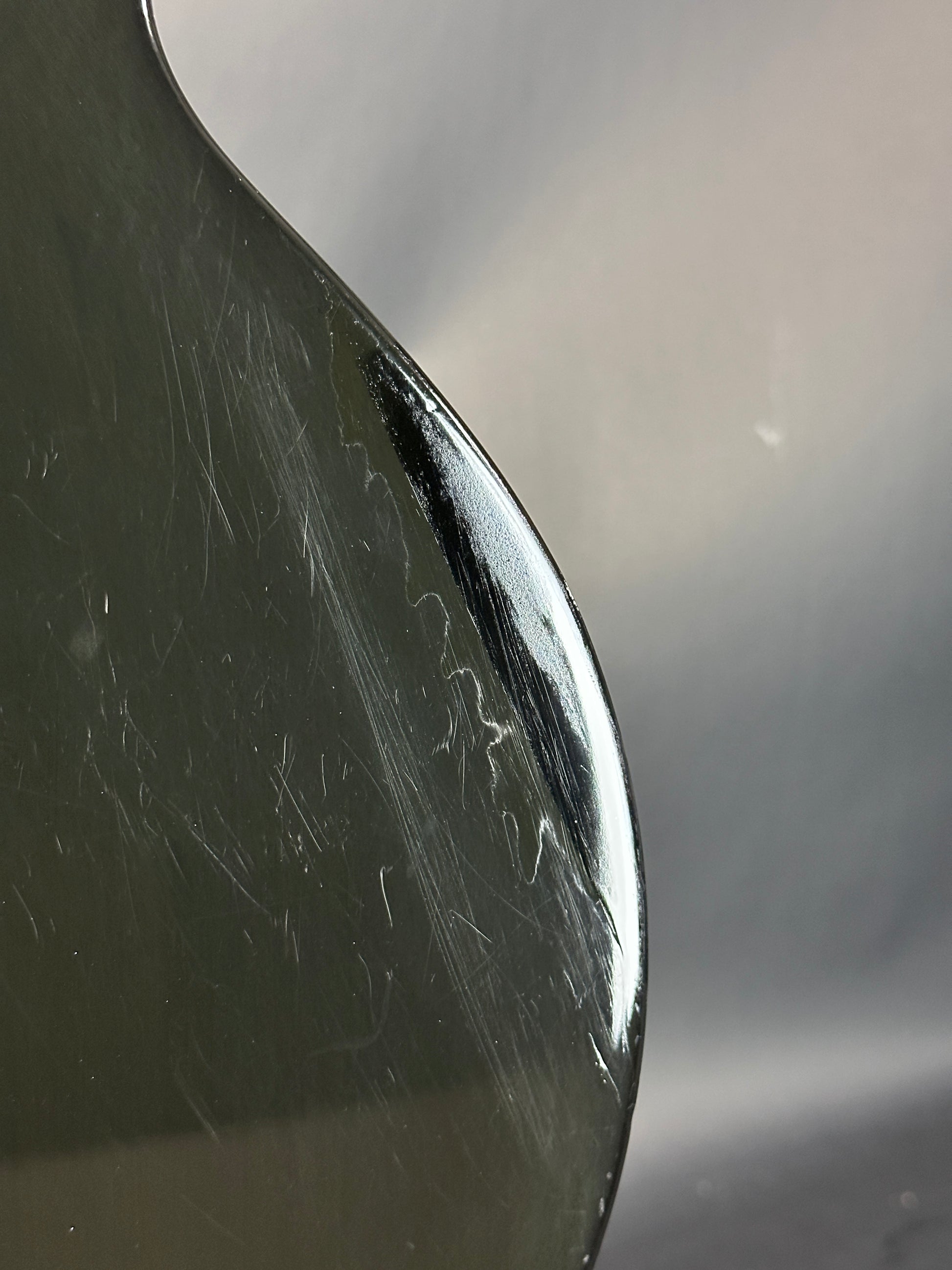Close-up of a spoon with visible scratches on its surface