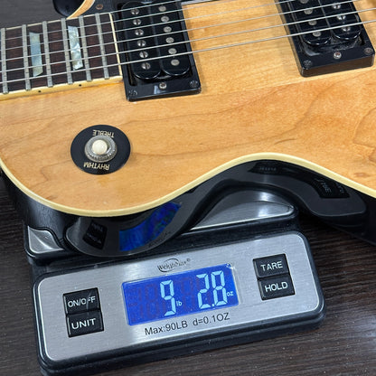 Electric guitar on a digital scale displaying weight