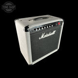A Marshall guitar amplifier with a cream-colored textured cabinet, black front grille, and silver control knobs, shown against a solid black background.