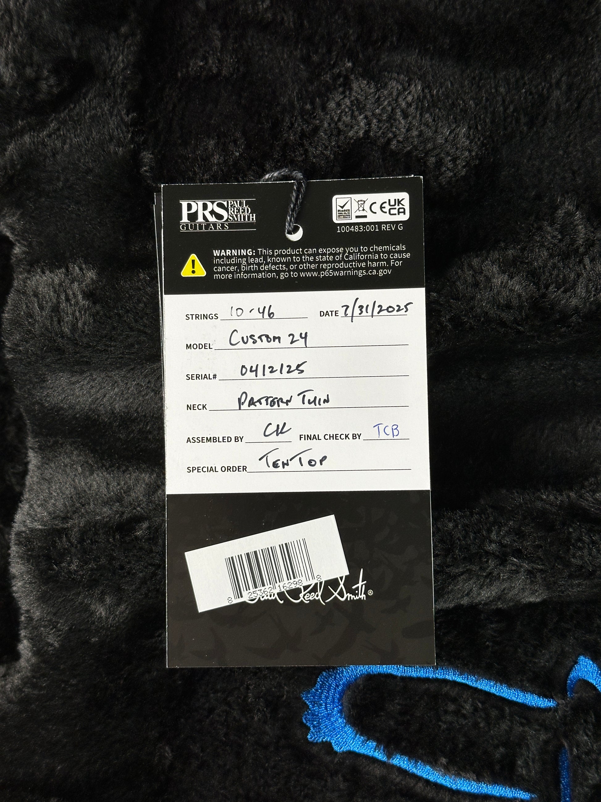 Close-up of a guitar tag on a black guitar