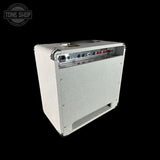 A white textured guitar amplifier cabinet shown at an angle against a solid black background, with a Tone Shop watermark in the top-left corner.
