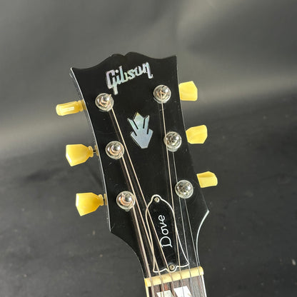 Gibson guitar headstock with 'Dove' branding on a dark background