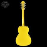 A bright yellow acoustic guitar shown from the back, photographed against a solid black background. A circular 'TONE SHOP' watermark is visible in the top-left corner.