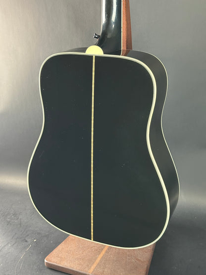 Close-up of an acoustic guitar's soundhole on a gray background