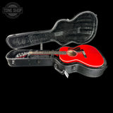 A red acoustic guitar inside an open black hard case on a black background, with a Tone Shop logo watermark in the top-left corner.