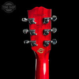 Close-up of the headstock of a red electric guitar against a black background, showing six tuning pegs, model number 20206105, 'MADE IN USA', and a gold-toned Gibson logo.