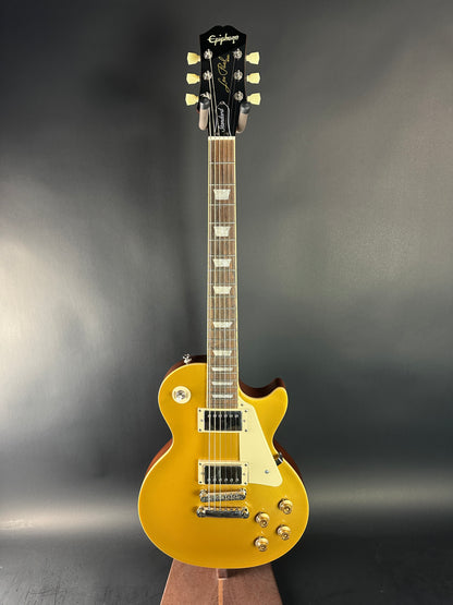 Gold electric guitar on a dark gray background