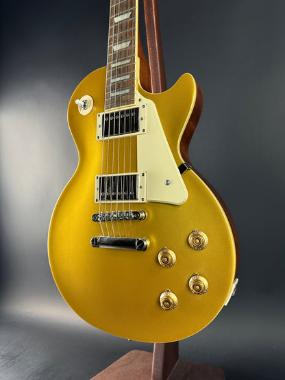 Gold electric guitar on a dark background