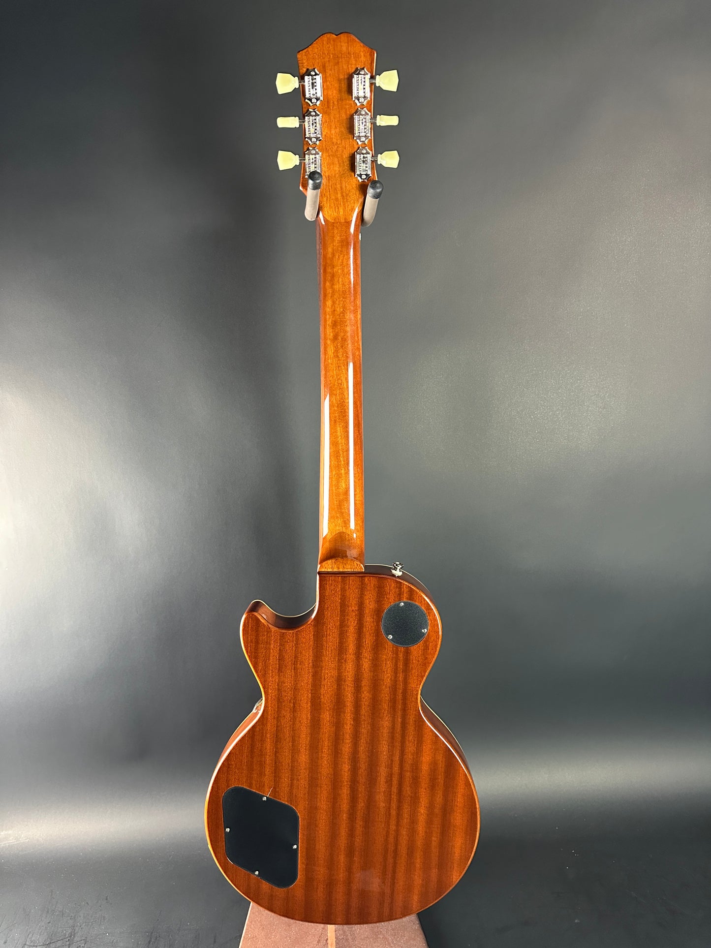 Wooden electric guitar on a gray background