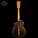 The back of an acoustic guitar with a dark brown wood grain body and a light natural wood center stripe, shown against a solid black background. A Tone Shop watermark is visible in the top-left corner.