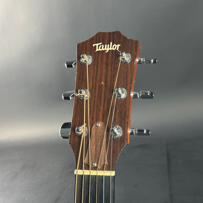 Taylor guitar headstock on a gray background