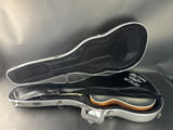Guitar case with a guitar inside on a reflective surface