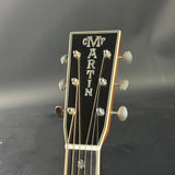 Gibson guitar headstock with brand name on a dark background