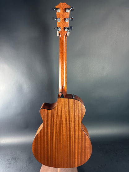 Wooden acoustic guitar on a gray background