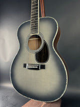 Acoustic guitar with a metallic finish on a dark background