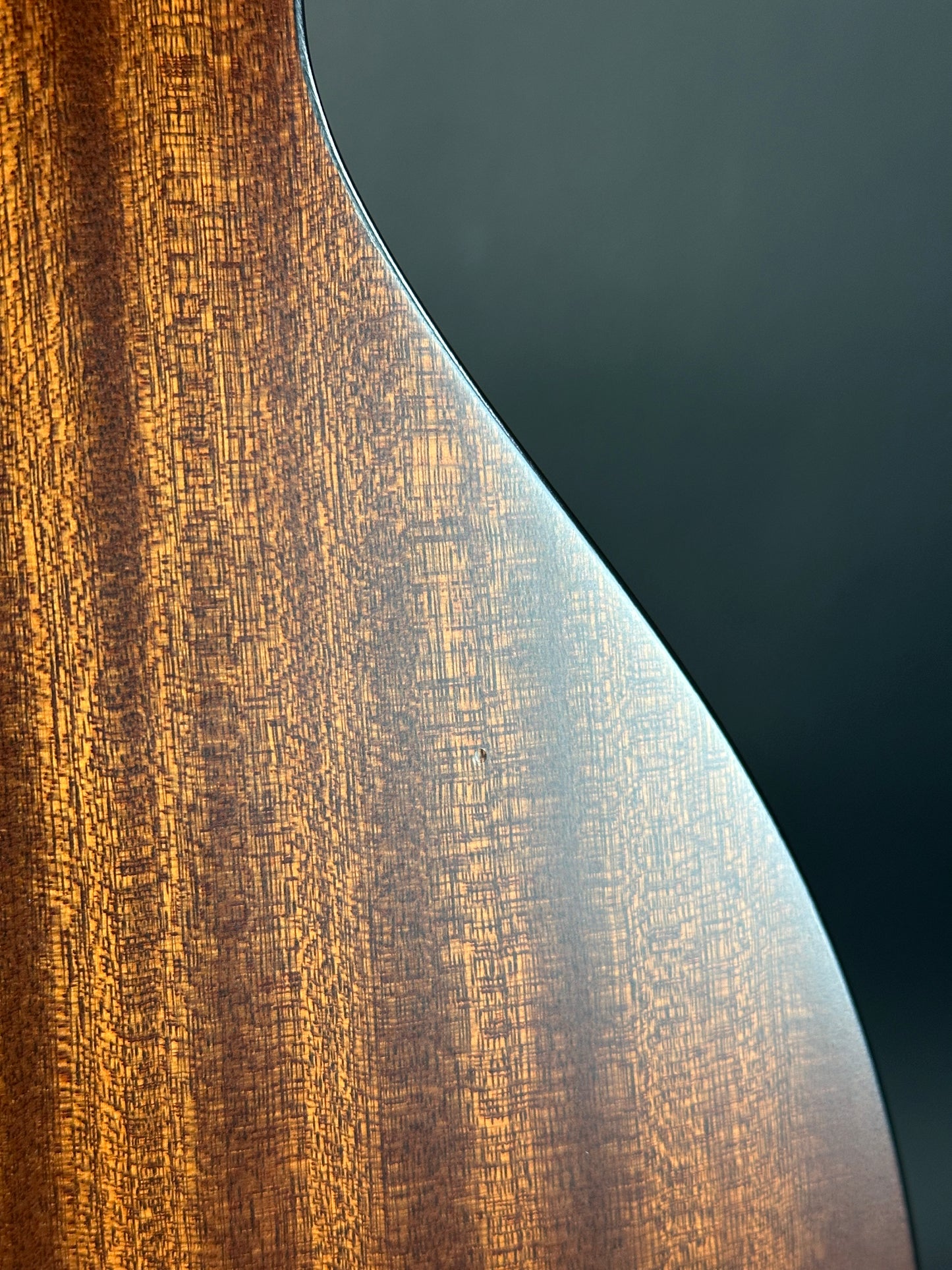Close-up of a wooden surface with a dark gray background