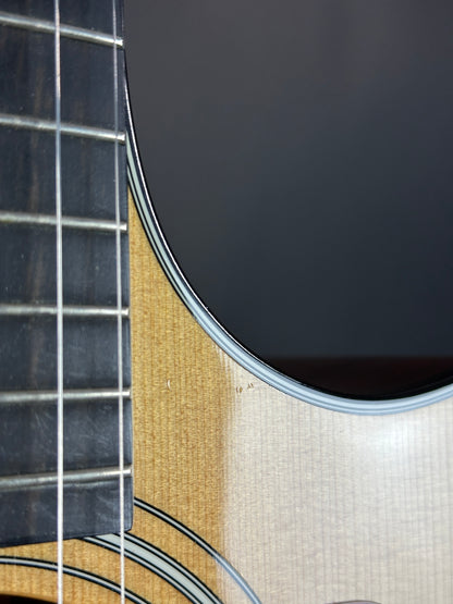 Close-up of an acoustic guitar's soundhole and fretboard