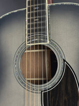 Close-up of an acoustic guitar's soundhole and strings on a dark background