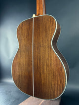 Close-up of a wooden acoustic guitar on a dark background