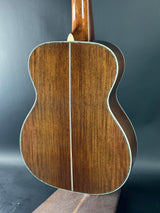 Close-up of a wooden acoustic guitar on a dark gray background