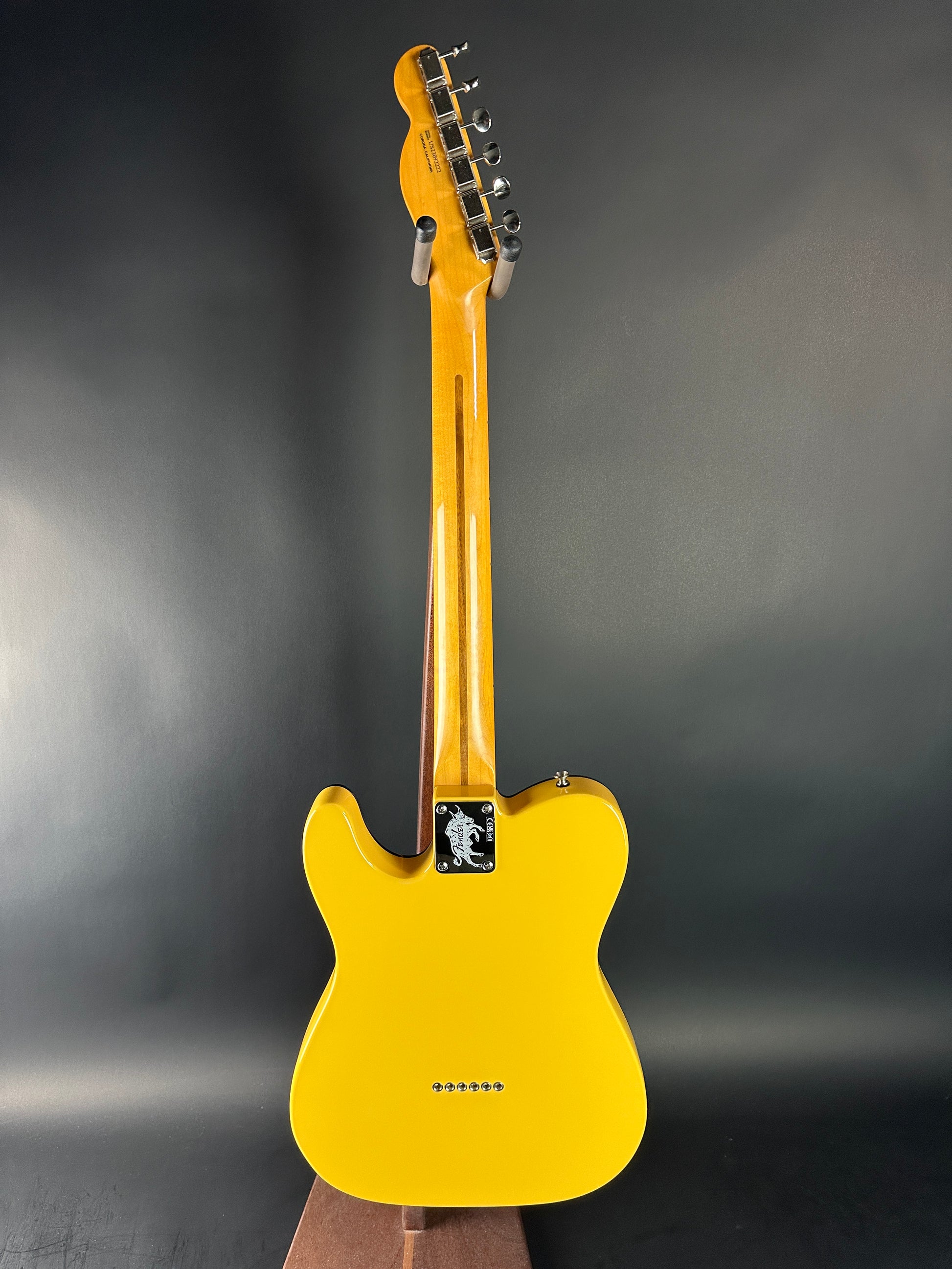 Yellow electric guitar on a dark gray background
