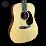 A natural wood acoustic guitar with a dark brown sides and neck, shown against a solid black background. A 'TONE SHOP' watermark is visible in the top-left corner.