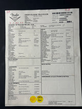 A white paper floor trailer form sheet with printed tables, barcodes, and notes, photographed on a dark surface.