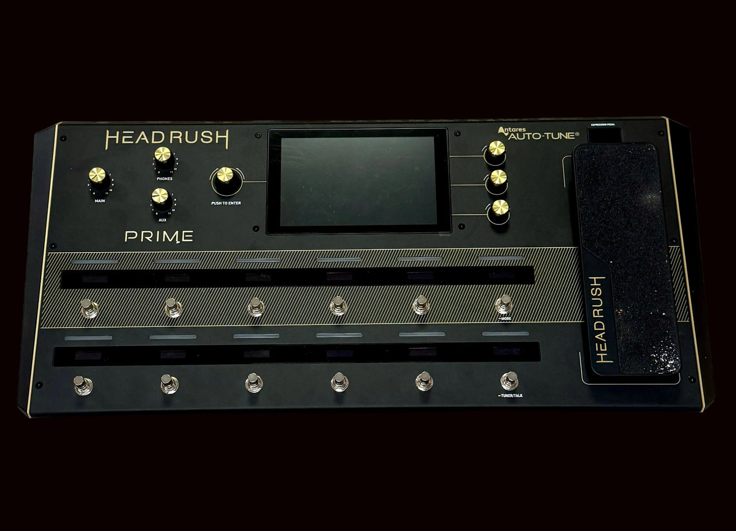 Black guitar effects pedal with 'HEADRUSH' branding on a wooden surface