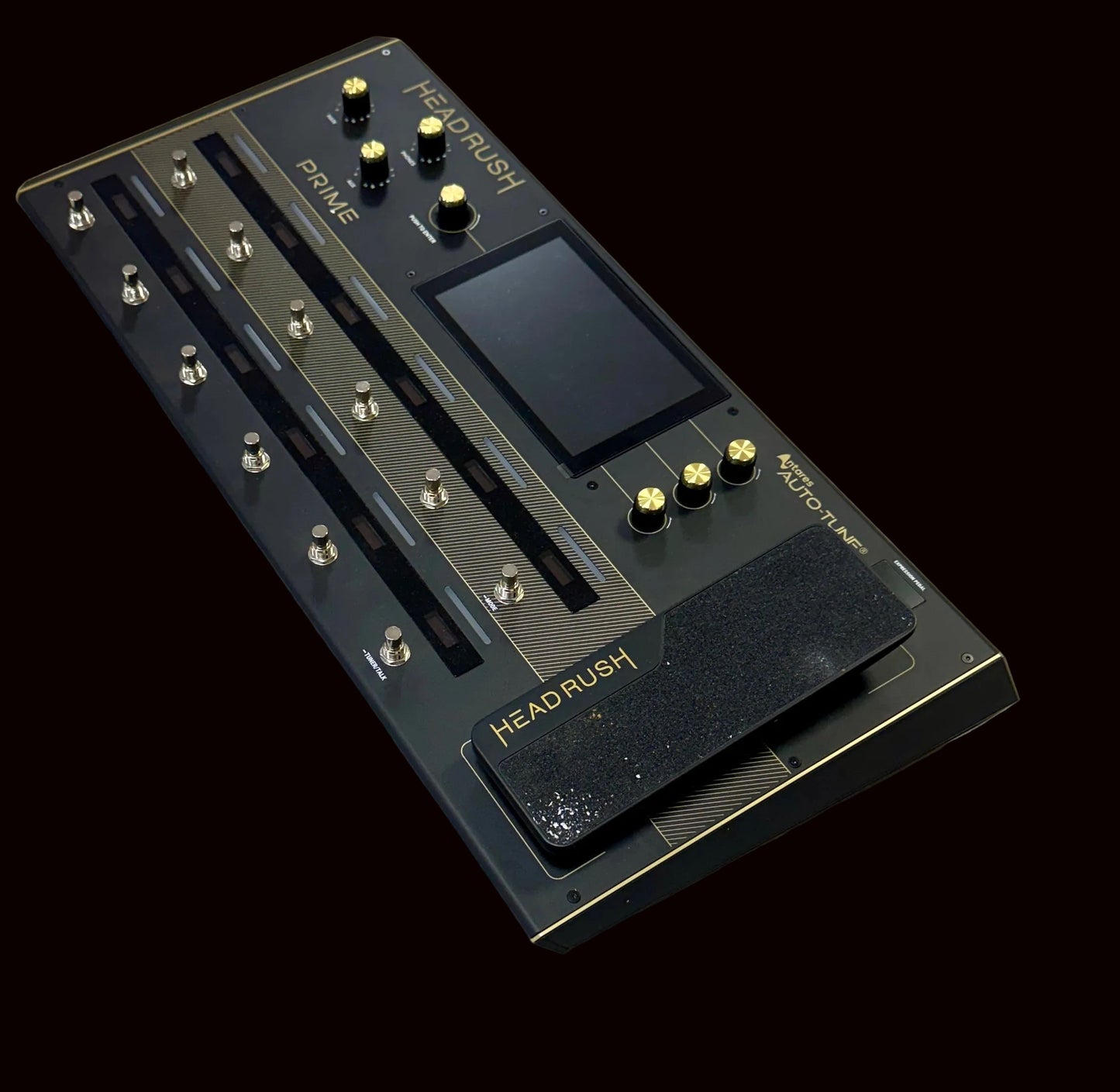 Black guitar effects pedal with 'HEADRUSH' branding on a wooden surface