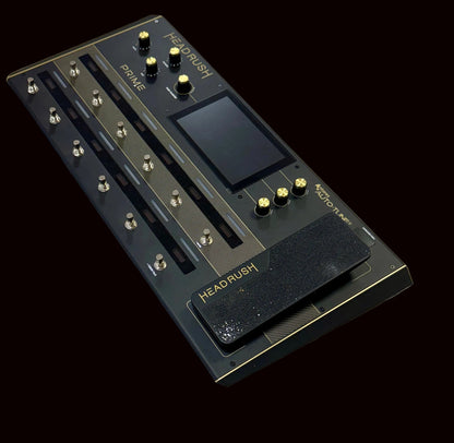 Black guitar effects pedal with 'HEADRUSH' branding on a wooden surface