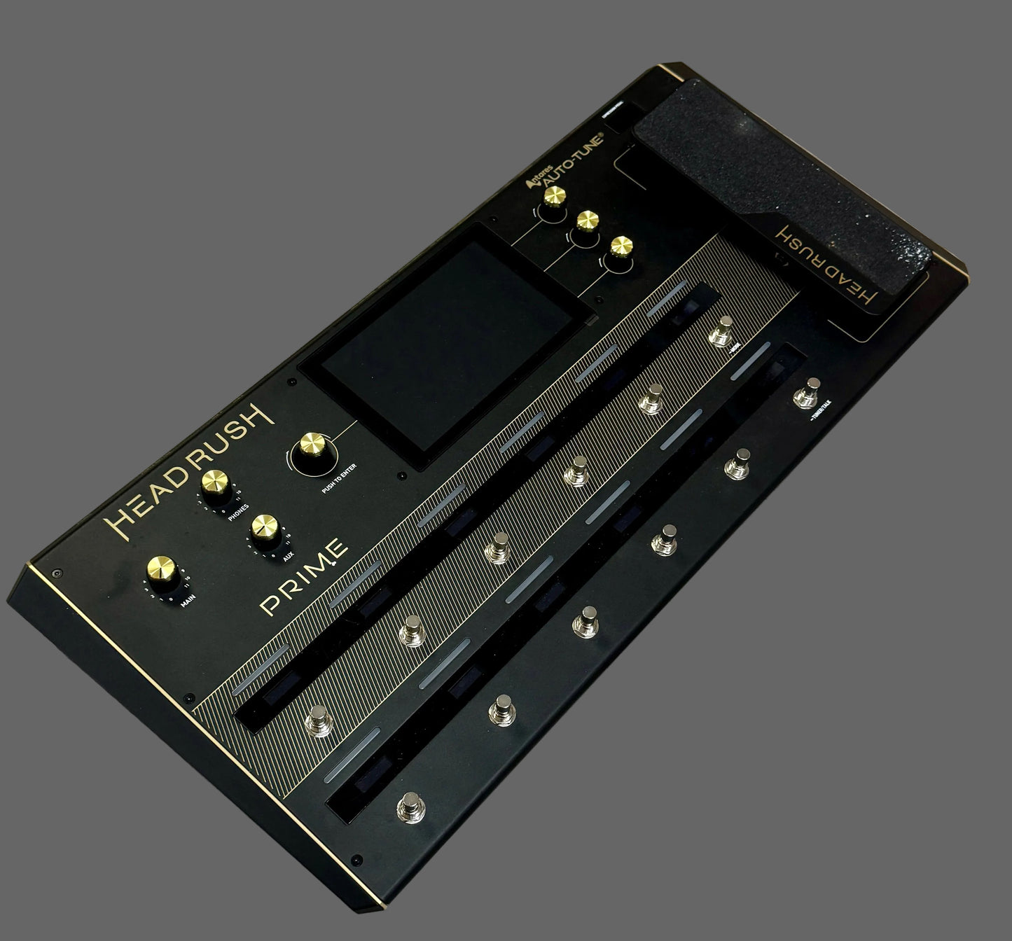 Black guitar effects pedal with 'HEADRUSH' branding on a wooden surface