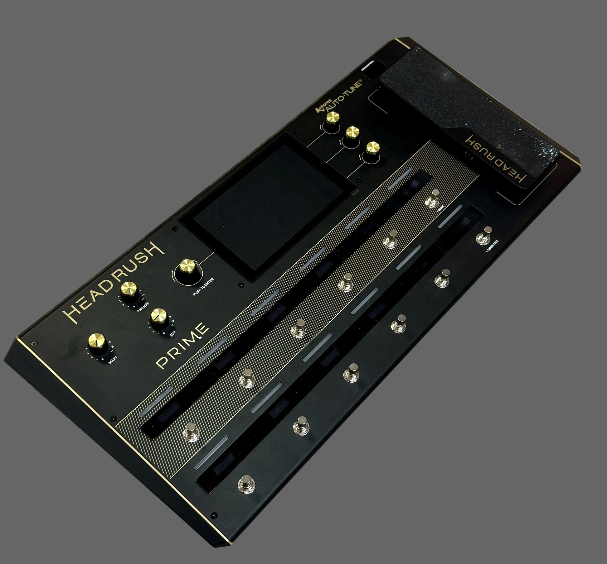 Black guitar effects pedal with 'HEADRUSH' branding on a wooden surface