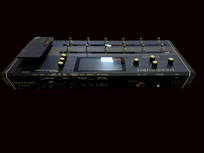 Black electronic device with buttons and display on a wooden surface