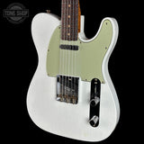 A white electric guitar with a light sage green pickguard, shown from the side against a solid black background. A Tone Shop watermark is visible in the top-left corner.
