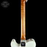 Close-up rear view of an electric guitar showing the white body, tailpiece, and a long maple neck with a prominent figured wood grain finish, set against a solid black background.