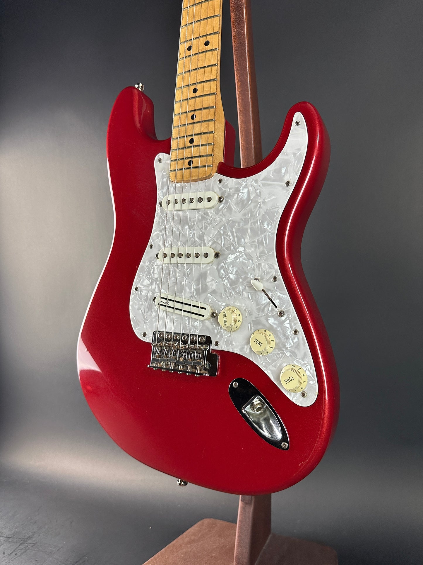 Red electric guitar on a gray background