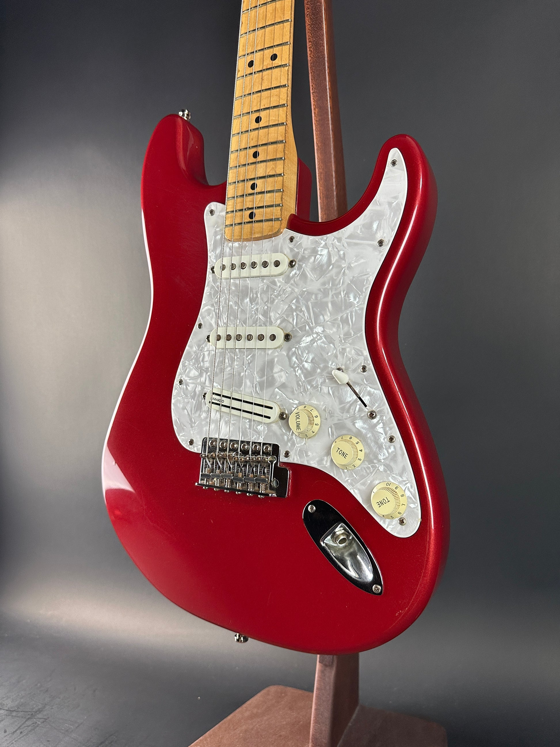 Red electric guitar on a gray background