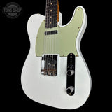 A white electric guitar with a light green pickguard, shown against a solid black background. A Tone Shop watermark is visible in the top-left corner.