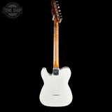 A white electric guitar shown from the back against a solid black background, with a Tone Shop watermark in the upper left corner.
