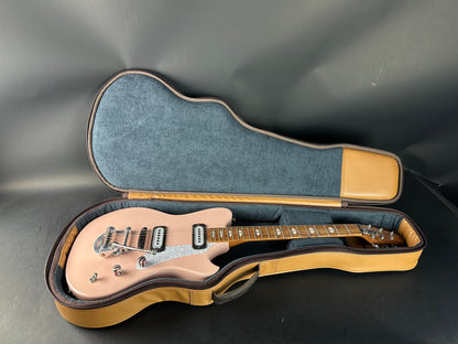 Electric guitar in a hard-shell case on a gray background
