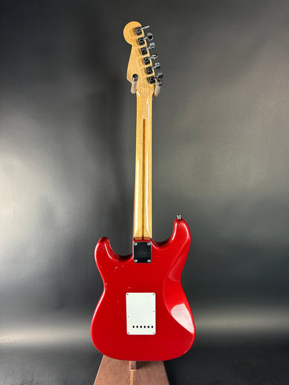 Red electric guitar on a dark gray background