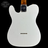 The back view of a white Fender Telecaster electric guitar body, featuring a black metal plate with 'Fender' and 'Tone Shop' branding, set against a solid black background.