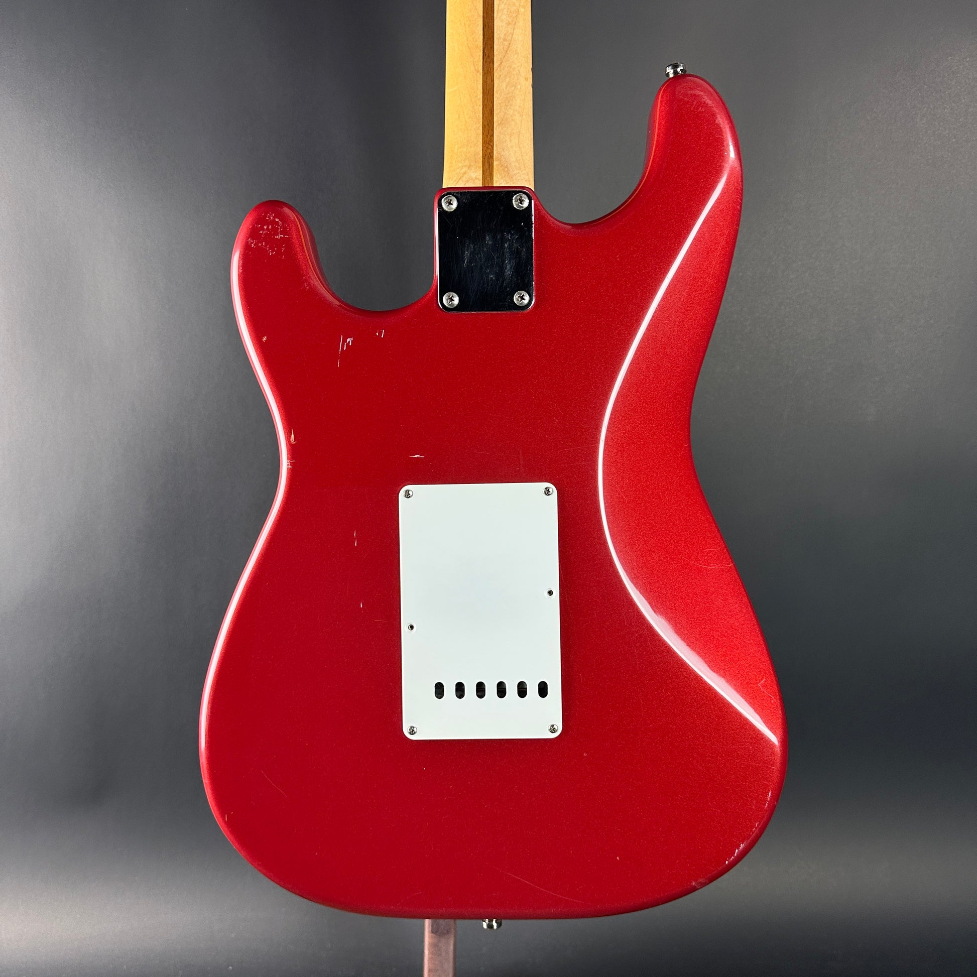 Red electric guitar on a gray background