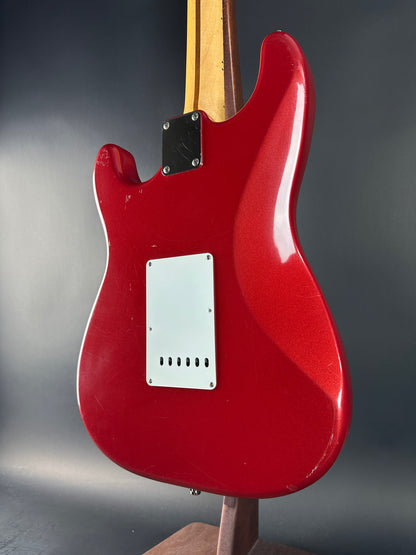 Red electric guitar on a gray background