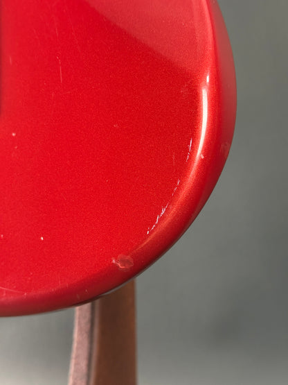 Close-up of a red object with a blurred gray background