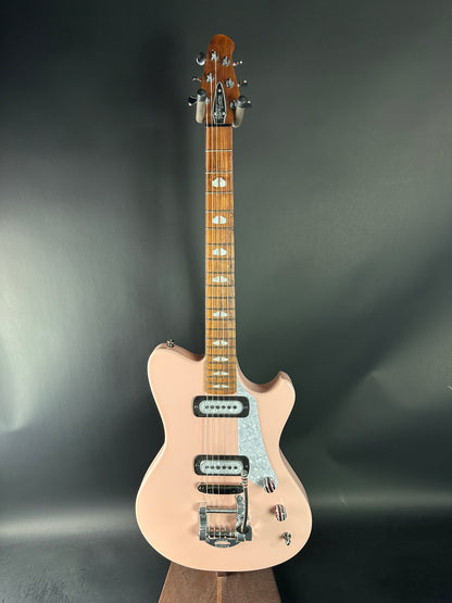 Beige electric guitar on a dark gray background