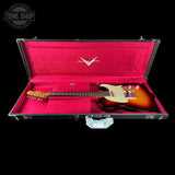 A Stratocaster electric guitar with a sunburst finish and cream pickguard, displayed inside an open black hard case with a bright pink velvet interior. The Gibson logo is visible on the inside lid, and the headstock reads 'GIBSON STRATOCASTER'.