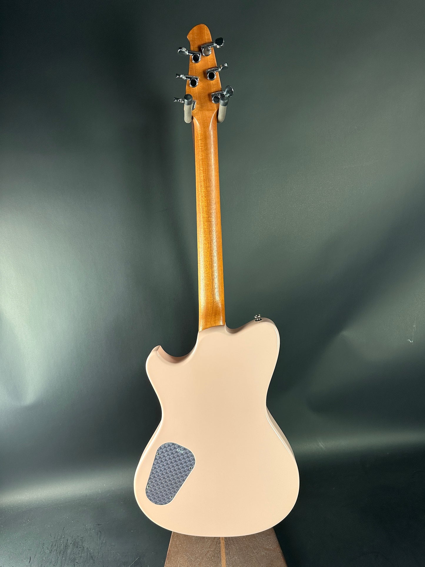 Back view of a guitar with a dark gray background