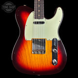 A classic Fender Telecaster electric guitar with a sunburst finish, featuring a cream-colored pickguard and chrome hardware, shown against a solid black background with a Tone Shop watermark in the top left corner.