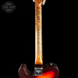 Close-up of the back of an electric guitar showing the tailpiece, lower body, and neck joint against a black background. A Tone Shop watermark is visible in the upper left.